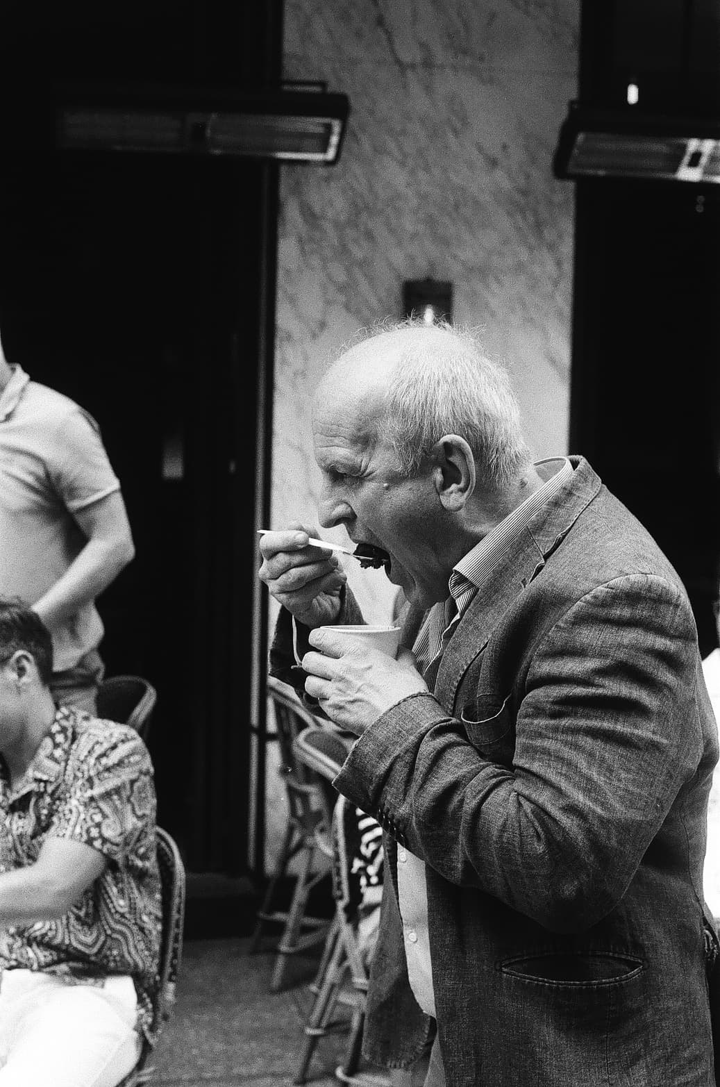 Barthelemy de Mazenod | People of Paris | A man eating an ice cream while walking in the street