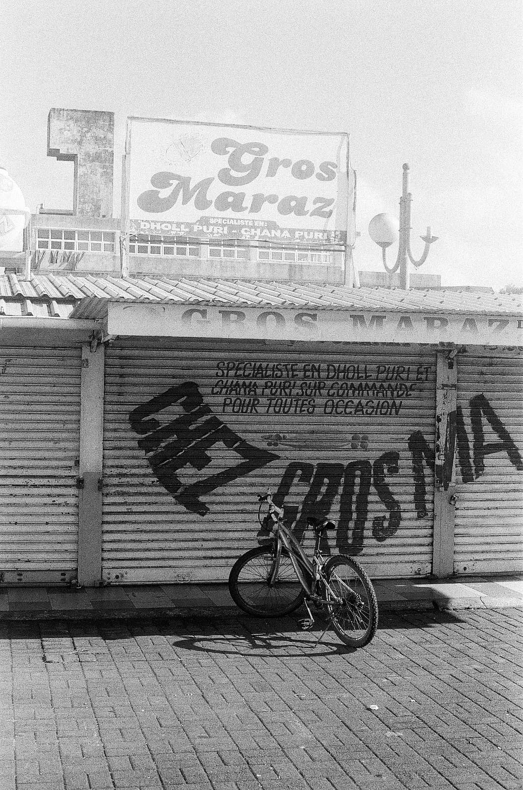 Barthelemy de Mazenod | Travel | A bike in front of a closed shop in Mauritius
