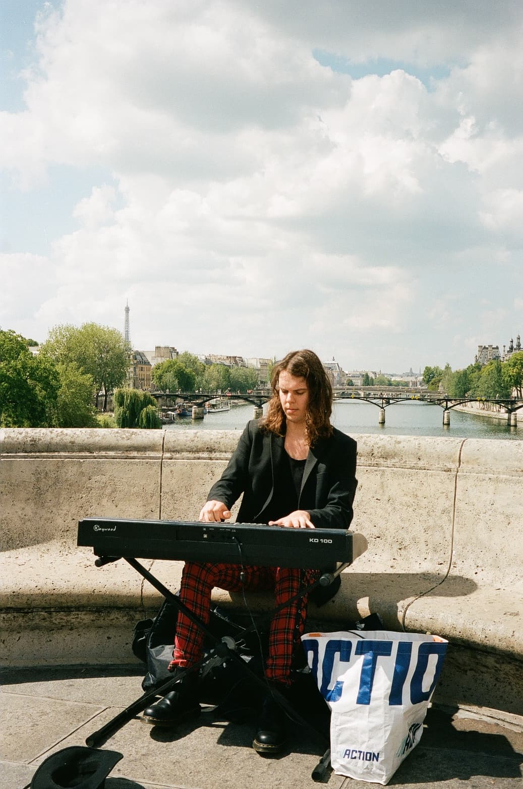 Barthelemy de Mazenod | People of Paris | A man playing piano on a bridge above the Seine