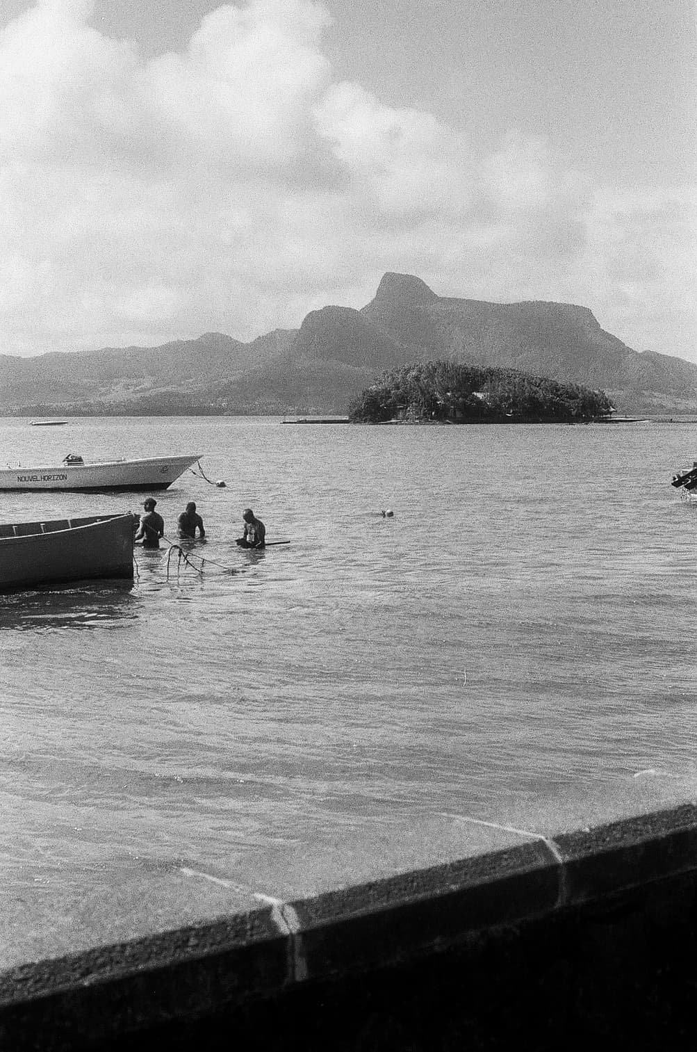 Barthelemy de Mazenod | The Seafront | Fishermen working in the water in Mauritius